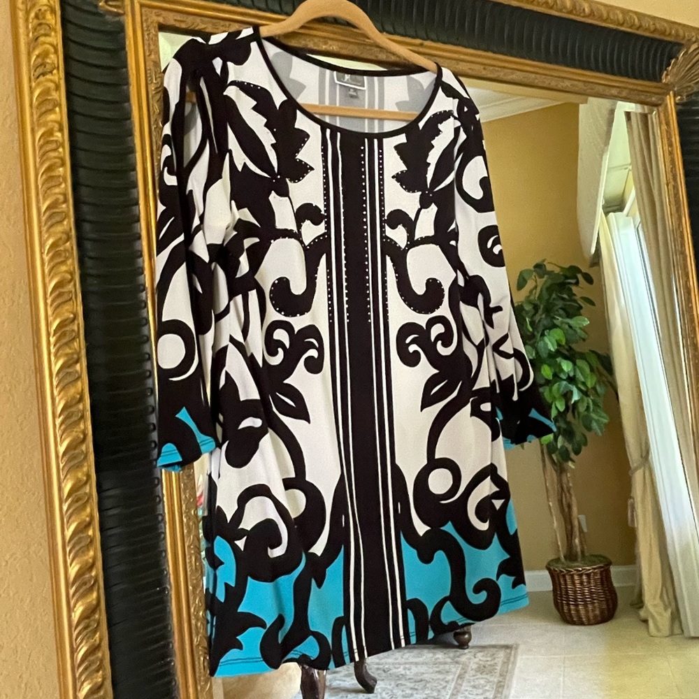 Size medium top with cutouts on sleeves.